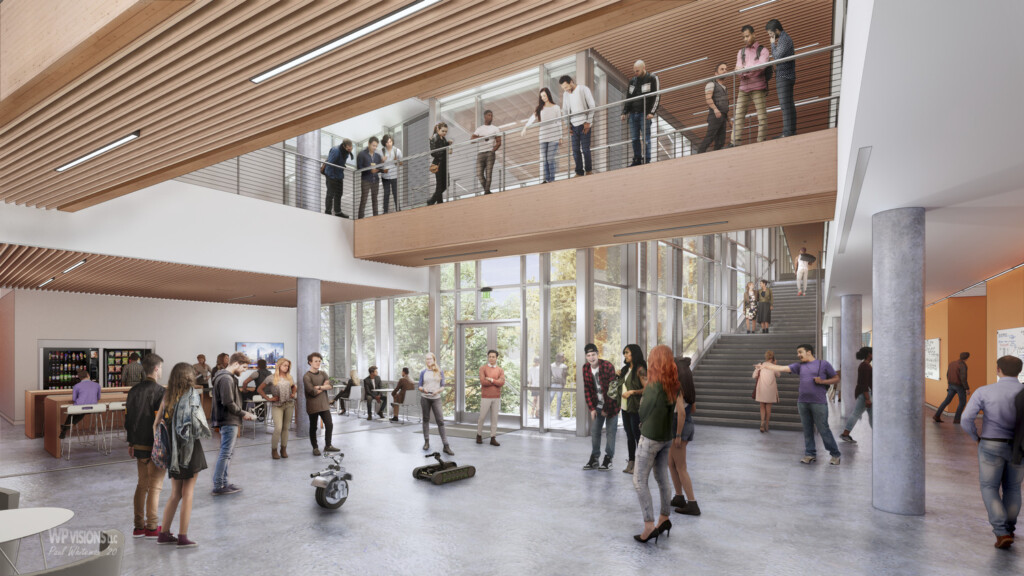 A modern, two-story atrium with glass walls and wooden accents at Northwest Vista College is bustling with people interacting and observing robotic devices on display. Upstairs, more people gather along a balcony in this vibrant STEM Learning Center.