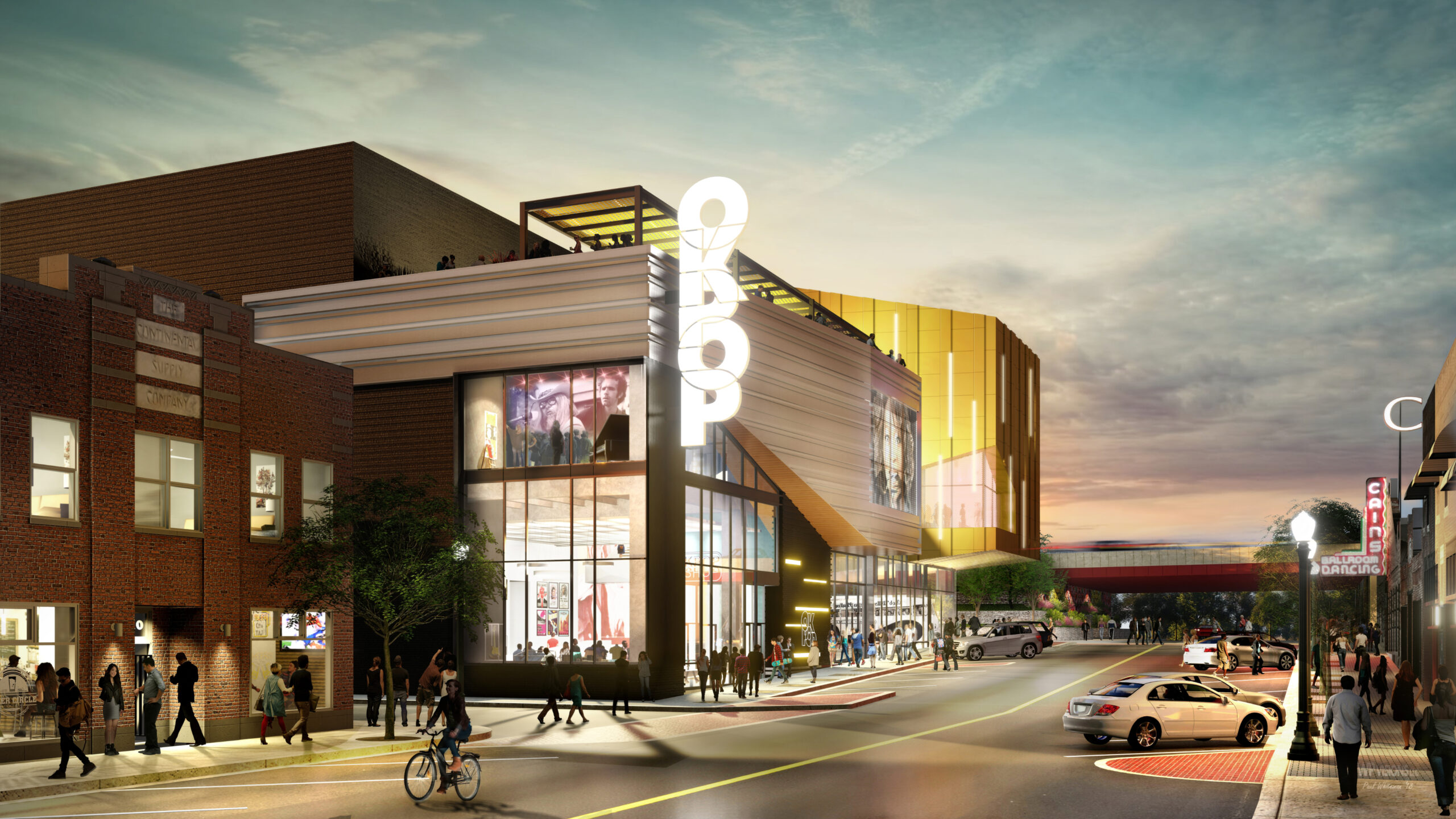 A modern urban theater with a lit marquee sign reading "OROP," people walking and biking on the sidewalk, and parked cars along the street, captured during twilight.