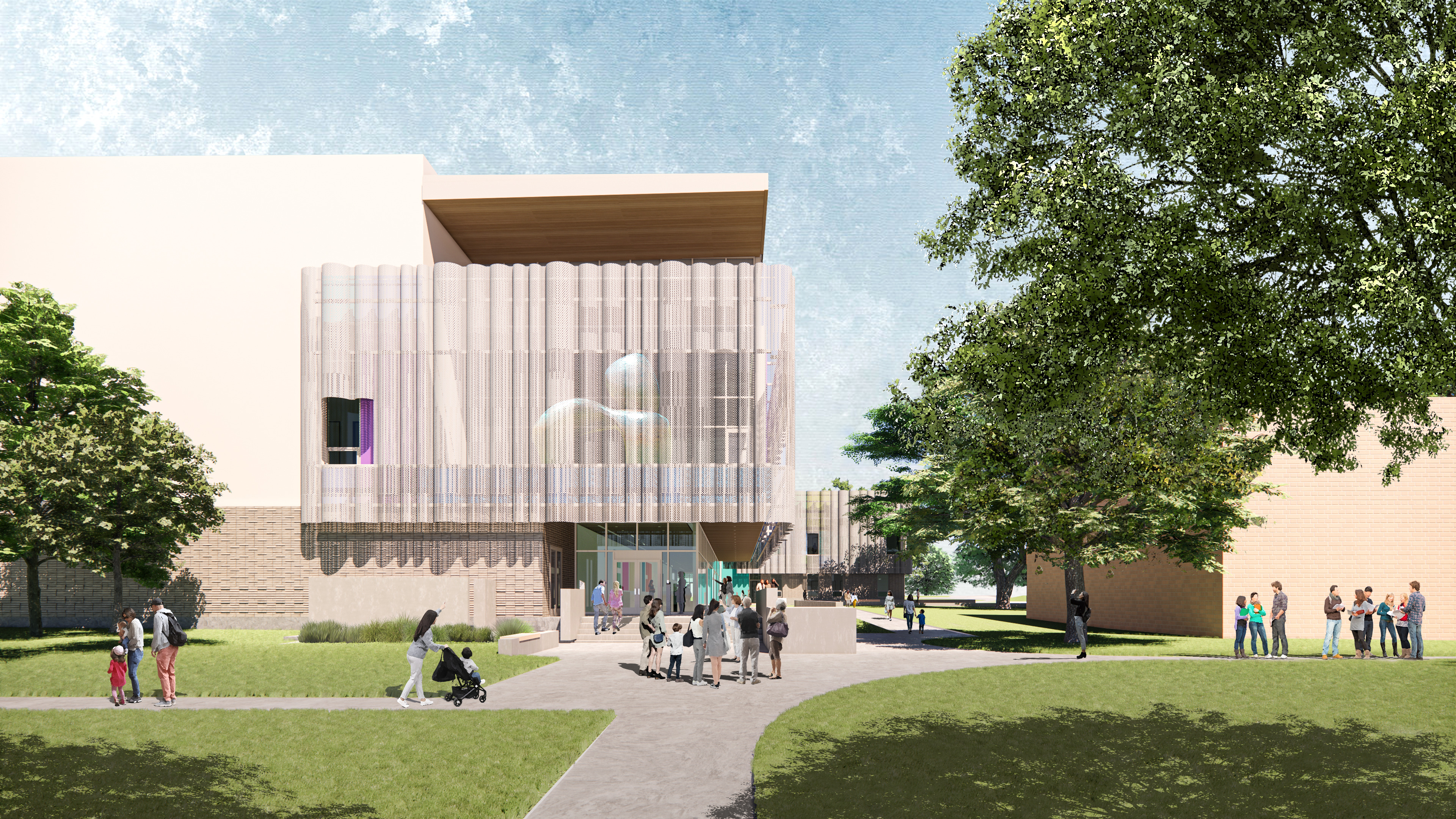 A modern building with a translucent facade, the Dougherty Arts Center in Austin features an entrance at the center, surrounded by trees. Several people are walking and gathering in the grassy area in front of the arts center.