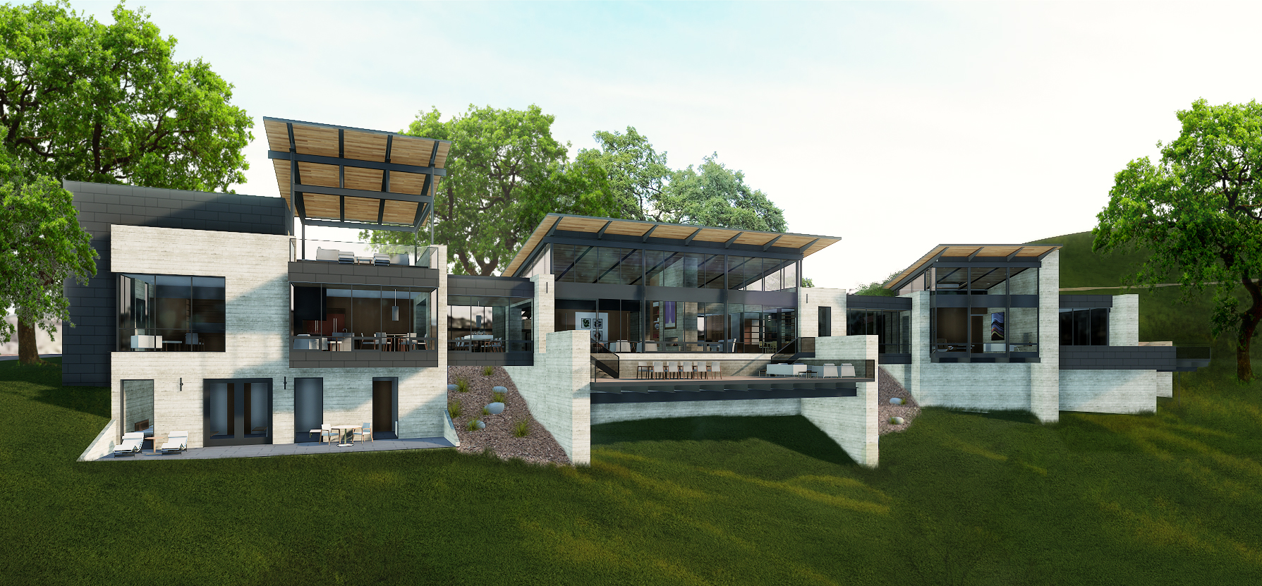 A modern, multi-level house with large windows, open terraces, and a mix of concrete and wood elements, surrounded by green trees and landscaping on a grassy slope overlooking MoonSprings Vineyard.