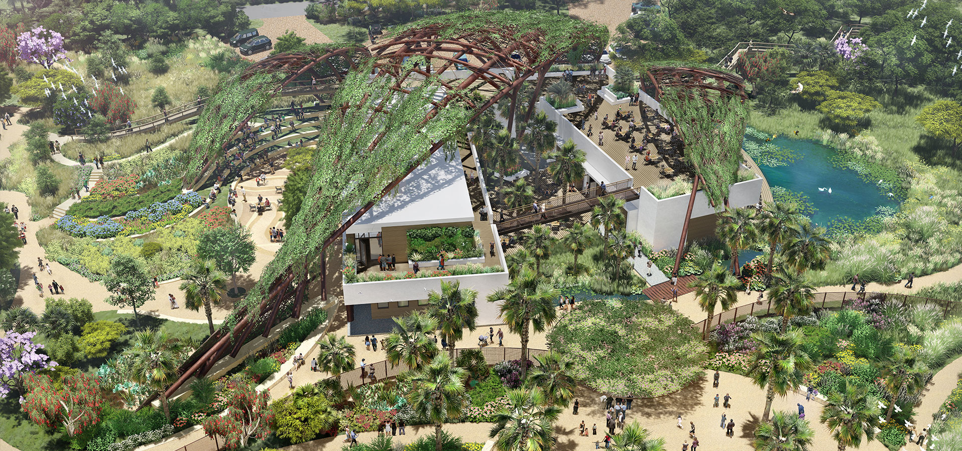 Aerial view of a lush outdoor environment featuring numerous plants, trees, pathways, and structures with a unique, partially covered canopy. People are walking around and exploring the area at Quinta Mazatlán, part of the renowned World Birding Center.