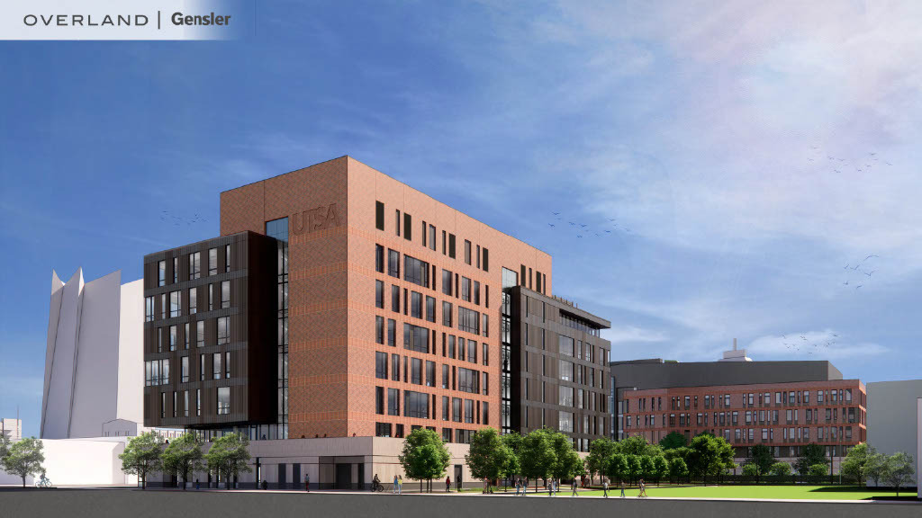 Exterior view of a modern multi-story building with "UTSA" on its facade, set against a clear sky. Trees and walkways are visible at the ground level, marking the San Pedro II campus of the University of Texas at San Antonio.