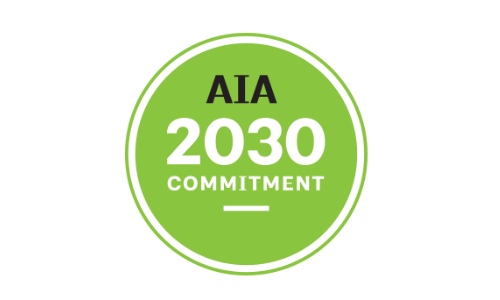 Green circular logo with "AIA 2030 Commitment" written in the center in black and white text, reflecting a dedication to Green Practices.