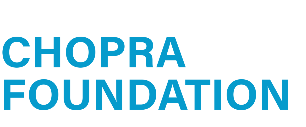 Text reads "Chopra Foundation" in blue uppercase letters on a white background, evoking the tranquil elegance of AMEYALLI Resort.