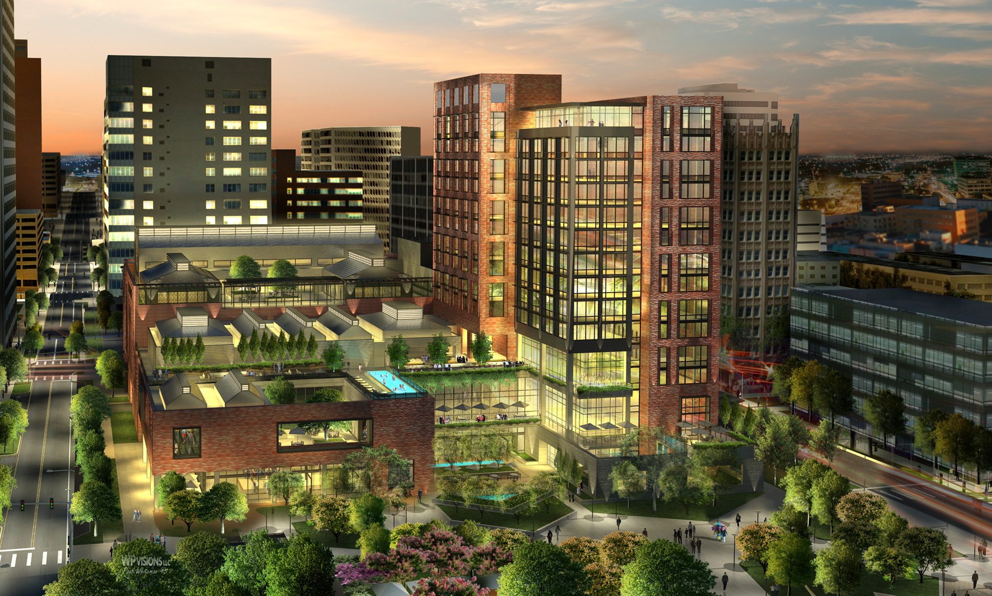 Aerial view of Santa Rita's modern, multi-story building complex in a cityscape at dusk, featuring green spaces and illuminated windows. This mixed-use development integrates urban living with nature seamlessly.