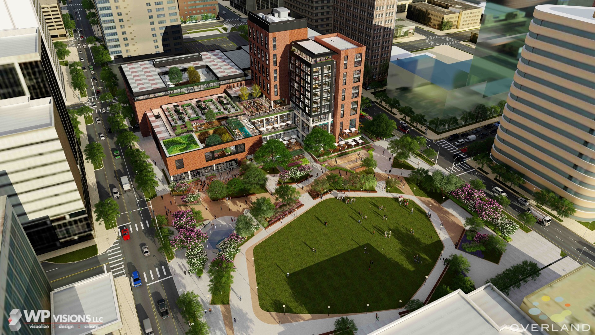 Aerial view of an urban park nestled in the Santa Rita district, surrounded by tall buildings. This mixed-use development features a large grassy area, trees, pathways, and a multi-story brick building adorned with rooftop gardens.